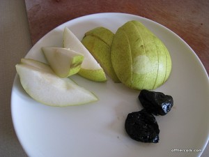 Sliced pear and two prunes 