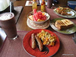Smoothie, eggs, sausage, and fruit 