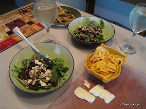 Salad, cheese, crackers, and wine