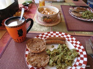 Coffee, eggs, sausage, fruit, and english muffin 