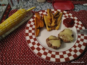 Burger, fries, and corn on the cob 