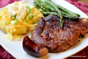 Grilled steaks, loaded baked potato, and asparagus