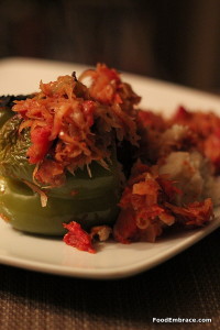 Mashed potato stuffed peppers with a tomato and sauerkraut sauce.